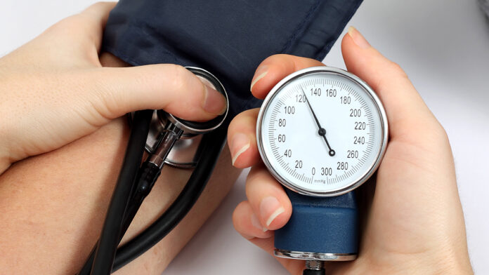 Doctor measuring blood pressure of a patient